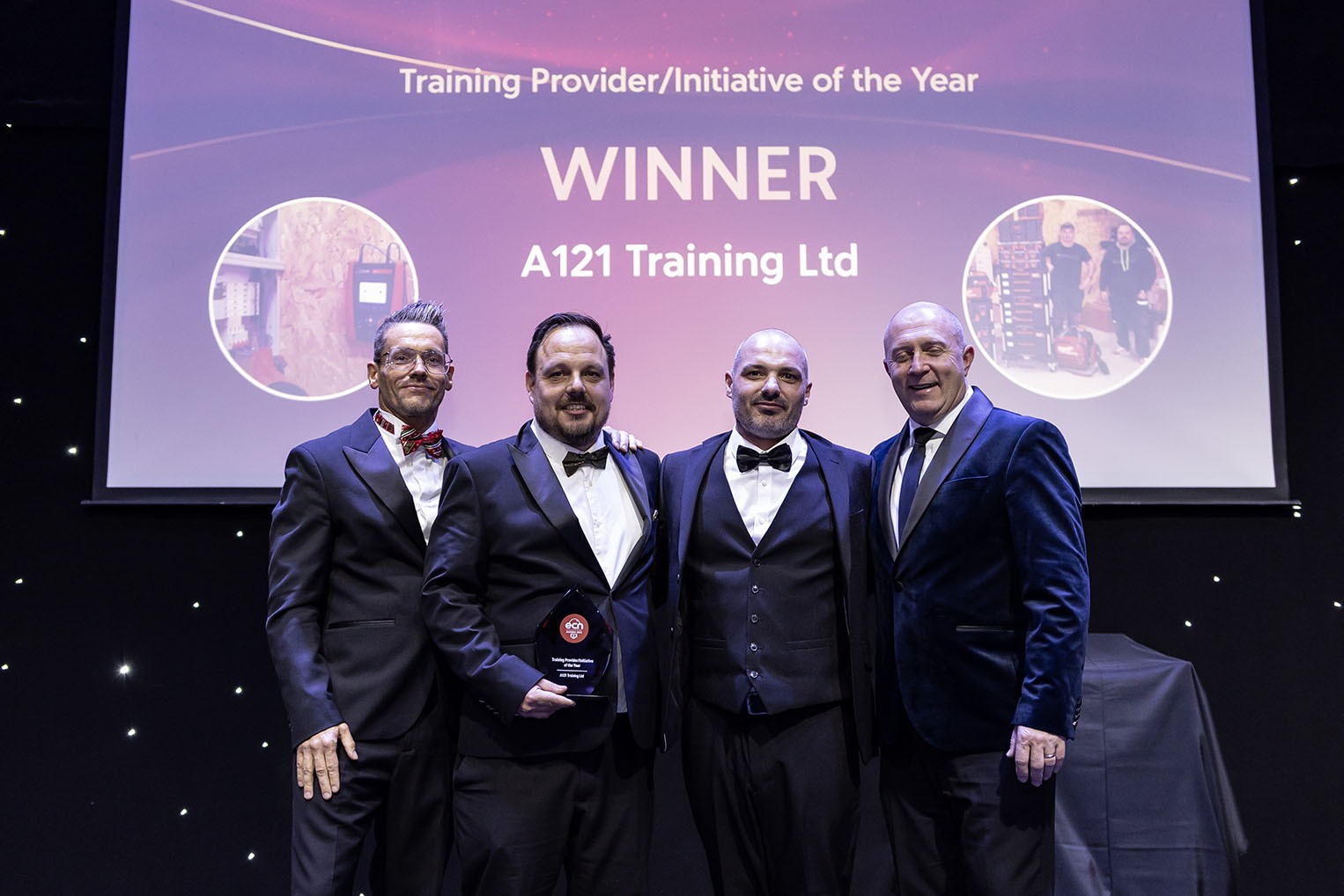 ECN Awards Stage photo with screen reading ‘Winner: A121 Training Ltd’ – Training Provider/Initiative of the Year"